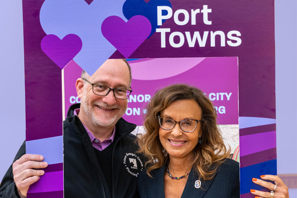 man and woman holding selfie frame for Port Towns