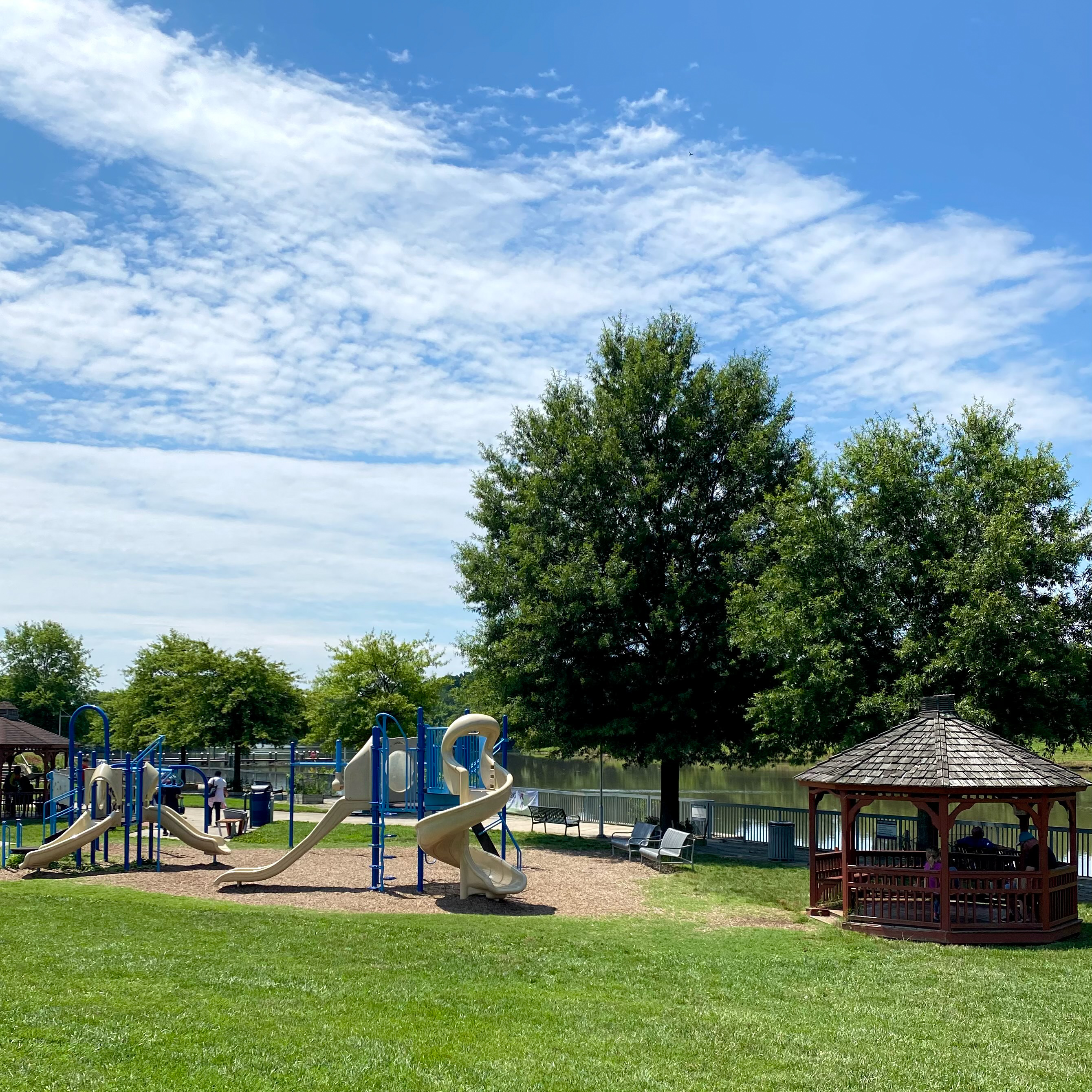 A large ployground with covered gazebo and slides.
